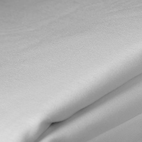 White pillow with grey embroidery stitching